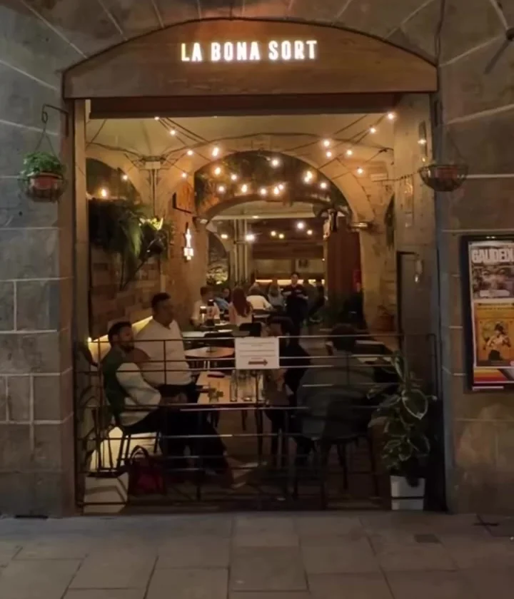 La entrada de La Bona Sort en el Carrer dels Carders, con el pasadizo iluminado al fondo